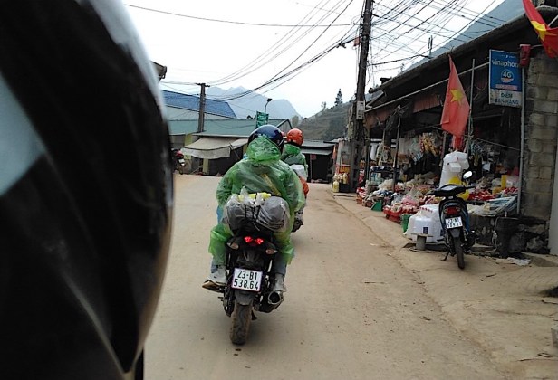 Riding through a village on the Ha Giang loop